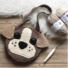 colorwork purse looks like a pug’s face. has long shoulder strap.