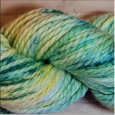 Bulky speckled yarn in lemon and lime tones.