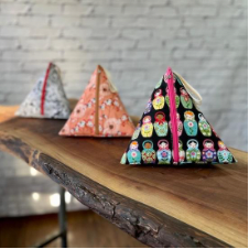 Medium size pyramid shaped zipper project bags. The one that’s in focus has Russian dolls on it.