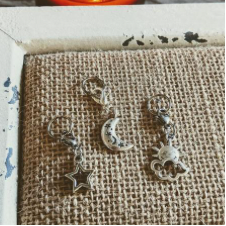 Metal stitch markers with rings. Charms are a star, the sun and the moon.