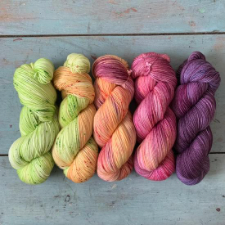 Bright variegated yarns in fruit and vegetation colors.