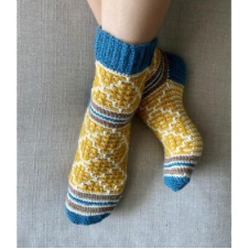 Mosaic socks in four colors with stripes at the toe and ankle and a diamond pattern throughout the rest. top of the cuff and heels are a solid contrasting color.