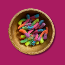 Wooden bowl full of realistic progress keepers that look like Gummy Worm candies.