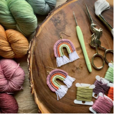 Rainbow shaped earrings with fringe.