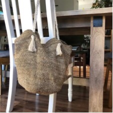 Closely crocheted hemp tote back with braided rope handles