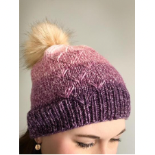 Knitted beanie with subtle drop stitch texture and pom-pom.
