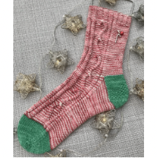 Socks in candy cane colors with a cable up the side in the shape of candy canes. Contrasting heel and toe in Christmas green.