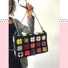 Rectangular purse made of granny squares with a chain shoulder strap.