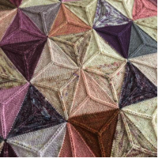 Scrappy blanket in hexagons made of six triangles.