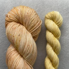 Yarn in wheat color plus mini skein in a butter color.