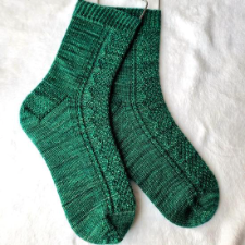 Socks with a wavy moss stitch path down the front.