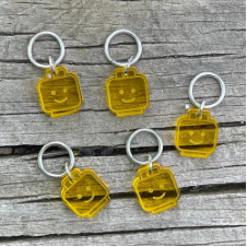Stitch markers in Lucite in the shape of the character heads from Lego sets.