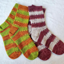 Striped socks that have X-shaped stitches along the edges of color changes.