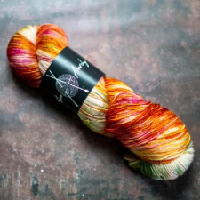 Variegated yarn in the colors of cream and flames, with a bit of cool water.