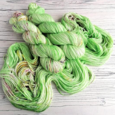 Spring green tonal yarn with warm, contrasting specks.