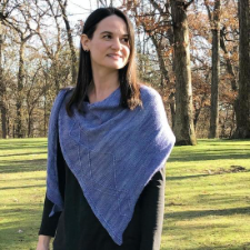 Triangular shawl with twisting traveling stitches to mimic the direction changes of flocks of birds. Has a buttonhole at the shoulder to hold the tails in place.