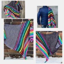 Triangular shawl is mainly black and white alternating row by row. One side has bright rainbow stripes.