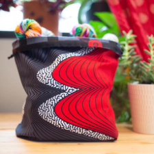 Drawstring bag with bright design similar to waves hitting the beach.