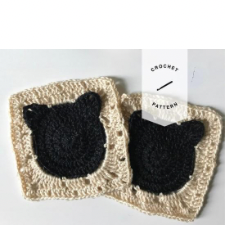 Granny squares with a round center in a second color. Cat ears are crocheted onto the circle to make a cat face silhouette.
