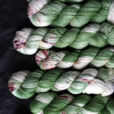 Variegated speckled yarn in the colors of leaves and lillies.