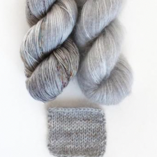 Tonal silver yarn with coordinating mohair skein. Sample shows subtle striping.