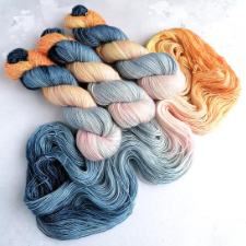 Variegated yarn in a mix of medium to light warm and cool tones.