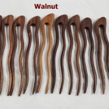 Two-pronged wavy wooden pin in walnut wood.