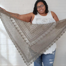 Large, lacy triangular crocheted shawl.