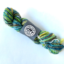 Single-ply variegated yarn in cool underwater tones.