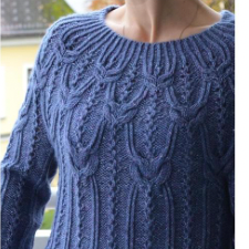 Long-sleeve pullover with twisted stitches and lace columns throughout.