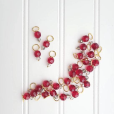 Stitch markers with blood red faceted crystals.