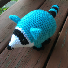 Aqua blue crocheted raccoon.