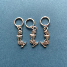 Metal stitch markers of beautiful mermaids.