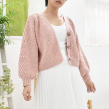 Crocheted cardigan with diamond-shape stitches. full sleeves gather at the cuff. Closure is three buttons.