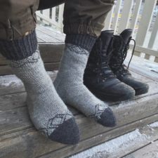 Toe up socks with simple, traditional Finnish motif near heel and top of cuff.