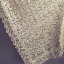 Rectangular shawl with a number of lace motifs.