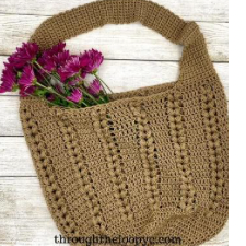 crocheted shoulder bag with vertical braids every few inches.