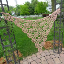 Lace shawl with star patterns joined together at the tips.
