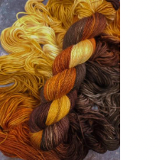 Variegated yarn in warm gold to chocolate brown.