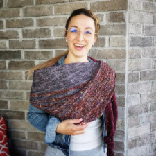 Assymetric triangle shawl in two colors. Horizontal stripes are in different colors and textures.