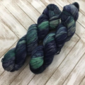 Dark variegated yarn in deep gray and lighter green.