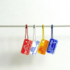Colorful rectangular etched boat charms on bulb safety pins.