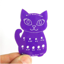 Cute, bright needle gauge in the shape of a smiling cat. looks about 2.5 inches long.