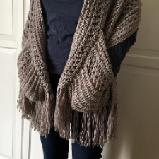 Generous chunky rectangular shawl with large pockets, plus long fringe at the short ends.