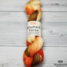 Variegated yarn in the color of falling leaves, on a cream base.