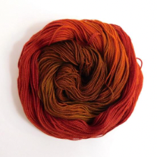 A variegated red/ochre/brown naturally dyed colourway inspired by the colouring of African Firefinches.