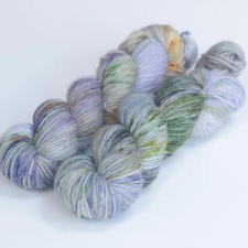 Variegated yarn in pale purples, golds and greens.