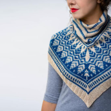 Cowl in two colors featuring motif reminiscent of pine cones. This cowl is knit flat in the shape of a triangle and then joined and worked in the round.