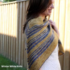 Triangular shawl mitered along the spine. Shown in stripes.