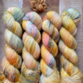 Warm variegated yarn in honey and peach with a bit of cool green.